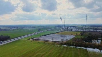 View from above on the German motorway A7 with some windmills for renewable electricity under construction. video