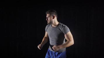 Sweaty and tired boxer man gets aggressive. Aggressive and angry boxer on black background. video