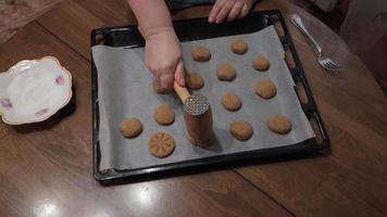 A woman makes a homemade cookie, she makes a pattern on the surface of the dough. video