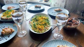 une magnifiquement ensemble à manger table avec une variété de délicieux vaisselle et salades. video