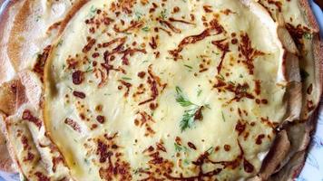 Delicious homemade pancakes with added herbs on a plate. video