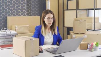 Overworked entrepreneur business woman selling in e-commerce. SME concept. Entrepreneurial businesswoman selling online and checking cargo packages.