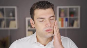 Man with headache rubs his head. Man with headache rubbing his head looking at camera. video