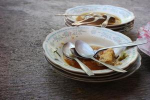 Selective focus stack of dirty dishes with food leftovers Unwashed dishes. photo