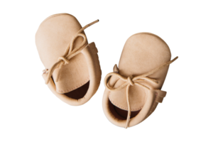 Beige baby shoes isolated on a transparent background png