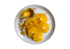 White plate with slices of orange fruit isolated on a transparent background