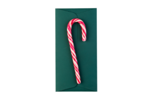 Red candy cane on a green envelope isolated on a transparent background png