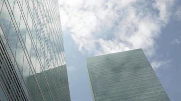 Modern office high rise skyscraper financial buildings in city business district. Looking up at modern glasses financial modern buildings up to sky with clear sky video