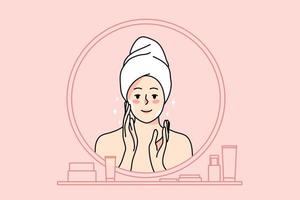 sonriente joven mujer en toalla después ducha Mira en espejo hacer Mañana facial cuidado procedimientos. contento niña aplicar cara crema para sano piel. protección de la piel tratamiento y belleza. plano vector ilustración.