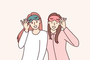 Friendly girls in pajamas with sleep masks are preparing to relax in comfortable bedroom with soft bed. Happy women use eye masks to protect themselves from sunlight during daytime naps or siestas vector