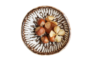 Brown nuts in a bowl isolated on a transparent background png