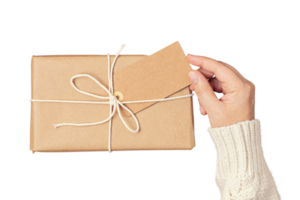 Beige gift box held by a woman's hands isolated on a transparent background png