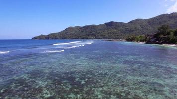 Slow flying drone across Anse forbans beach Mahe Seychelles video