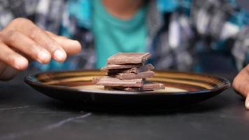 criança menino mão colher chocolate amargo em um prato video
