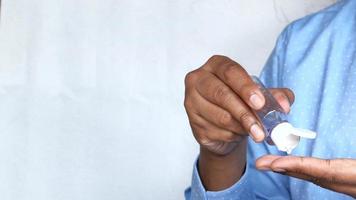 young man using hand sanitizer with copy space video