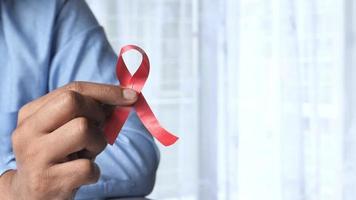 Red ribbon HIV symbol on hand video