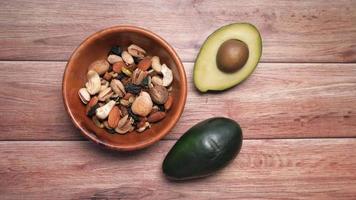 close up of slice of avocado and almond nut on chopping board video