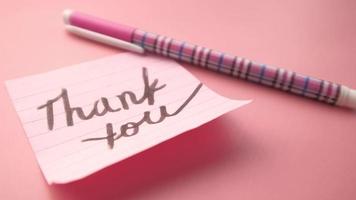 Thank you message on smart sticky note on pink background video