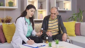 Female Doctor advises sick old man to use medicine and gives information about medicines. The woman doctor, who gives information about the drugs, tells the old man.