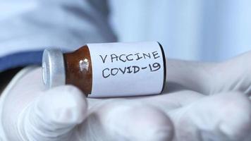 Healthcare cure concept , hand holding Covid 19 vaccine vial