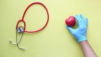 Stethoscope and heart shape on yellow background video