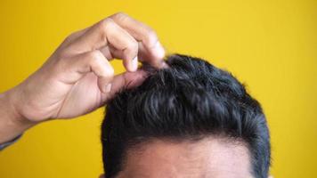 teenage boy Scratching Head Against yellow background video