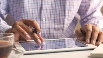 Man's hand working on digital tablet on office desk video