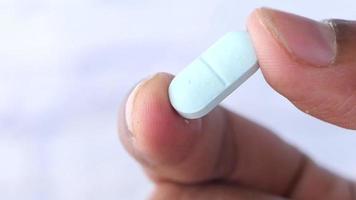 Close up of man hand holding pills with copy space