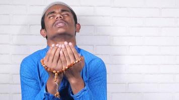 Muslim man keep hand in praying gestures during ramadan, Close up video