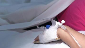 Baby hand with bandage giving saline on hospital bed video