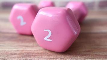 Pink color dumbbell on table close up video
