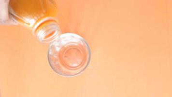 detail shot of pouring soft drinks in a orange color glass video