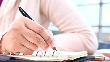 Close up of person hand writing on a diary video