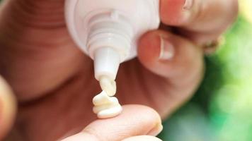 Close up of person hand using sunscreen cream outdoor video