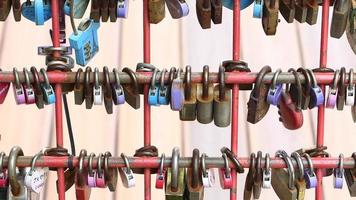 Many love padlocks locked on rusty iron gate in singapore video