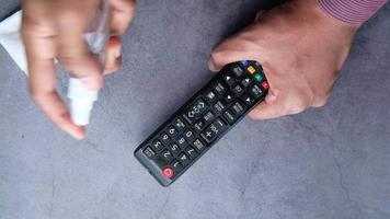close up of person hand cleaning tv remote video