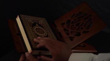 man open the holy Quran book on wooden table video