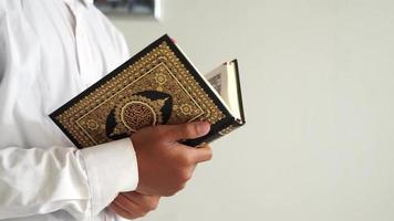 man holding a Quran book for copy space video