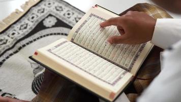 Man reading the holy Quran from top view video