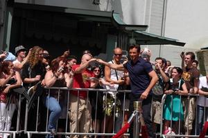Hugh Jackman giving a fan the pen used to sign name at the Hugh Jackman Handprint  Footprint Ceremony at Graumans Chinese Theater Forecourt in Los Angeles  California on April 21 20092009 photo