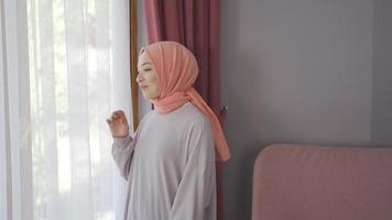 Happy Muslim woman in hijab is happy at home. Muslim woman at home is happy. video