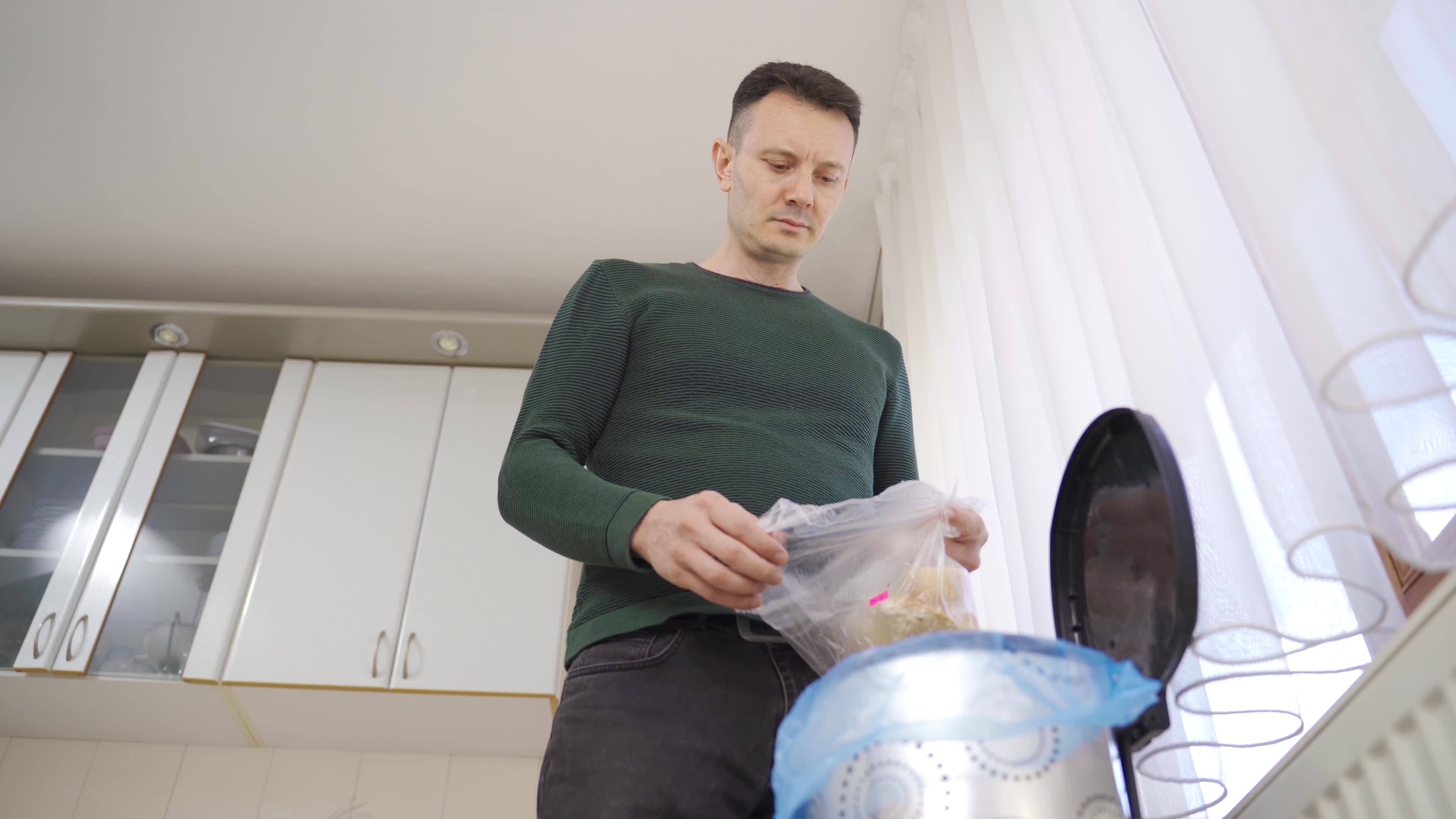 Man wastes food and throws food away. Waste. Throwing homecooked food