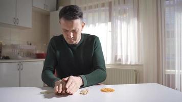 Food crisis. The man has very little food and tries to use it sparingly. As a result of the food crisis and the hunger crisis, the man tries to use his food sparingly. video