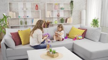 Clever little girl is playing brain teasers with her mother. The little girl is playing a brain game and her mother is accompanying her. video