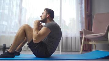 Young Man Exercising and Playing Sports at Home. Strong athletic fit man in t-shirt and shorts exercising at home. video