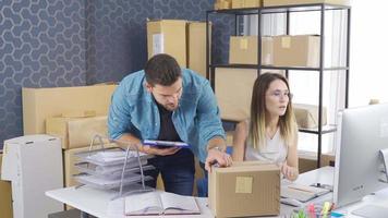 E-commerce. The couple, who sells online, delivers parcels and goods to cargo. The new enterprising couple is excited and shipping their goods and happily clapping their hands. video