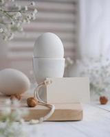 Easter breakfast decor and blank white card for text. Mockup tag. Easter card photo