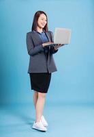 Asian businesswoman on blue background photo