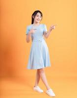 Young Asian woman wearing dress on background photo