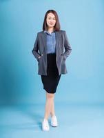 Asian businesswoman on blue background photo